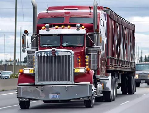 red-semitruck-driving-down-highway_1388397-2122